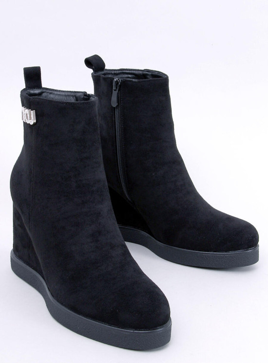 Black ankle boots on a wedge heel