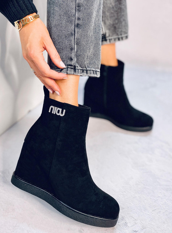 Black ankle boots on a wedge heel