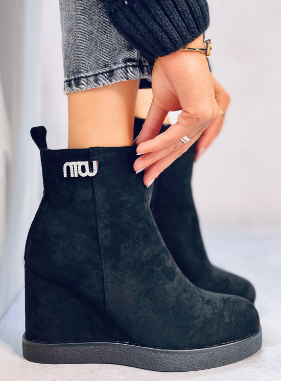 Black ankle boots on a wedge heel