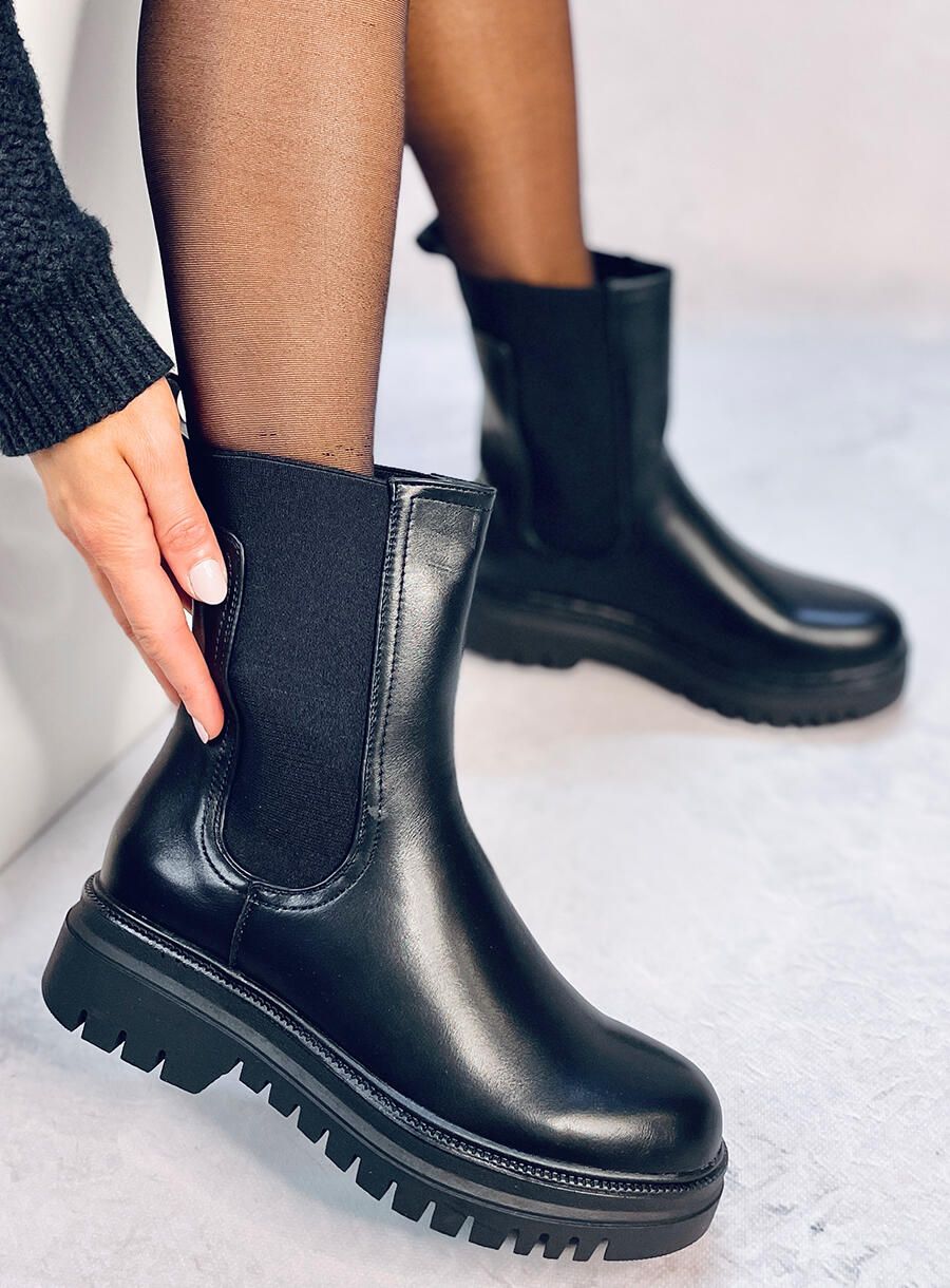 Black boots made of eco-leather on the platform