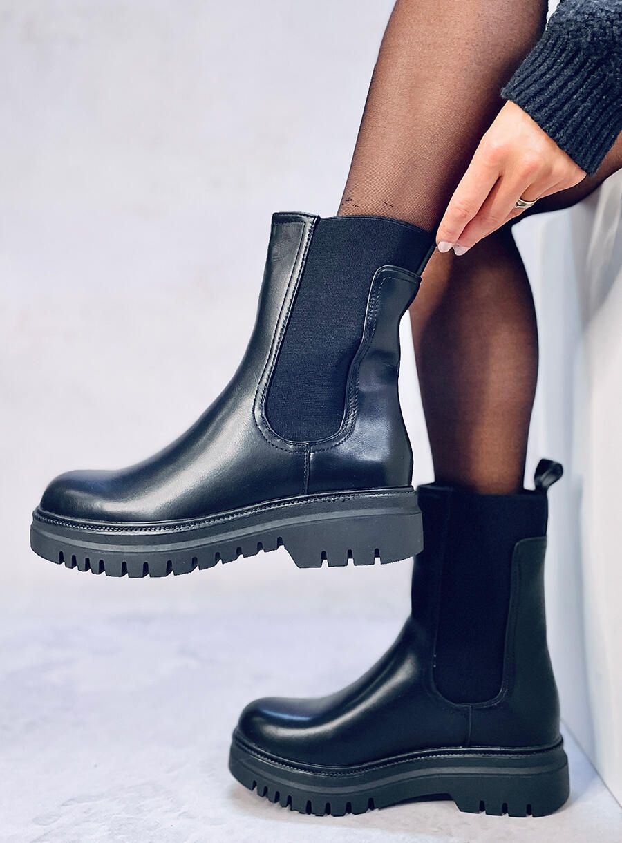 Black boots made of eco-leather on the platform