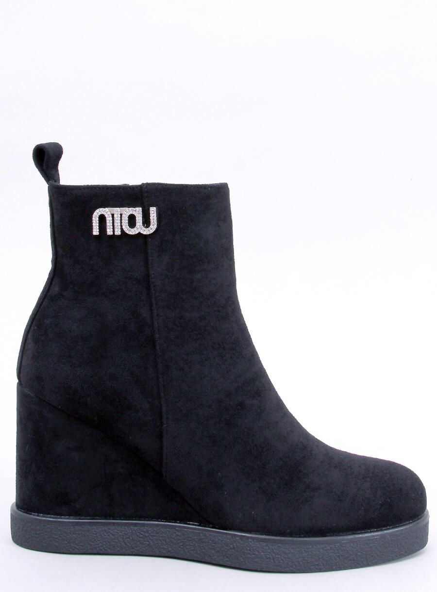 Black ankle boots on a wedge heel