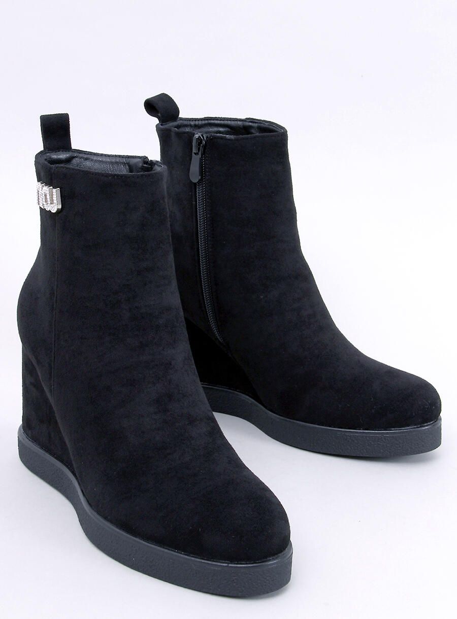 Black ankle boots on a wedge heel