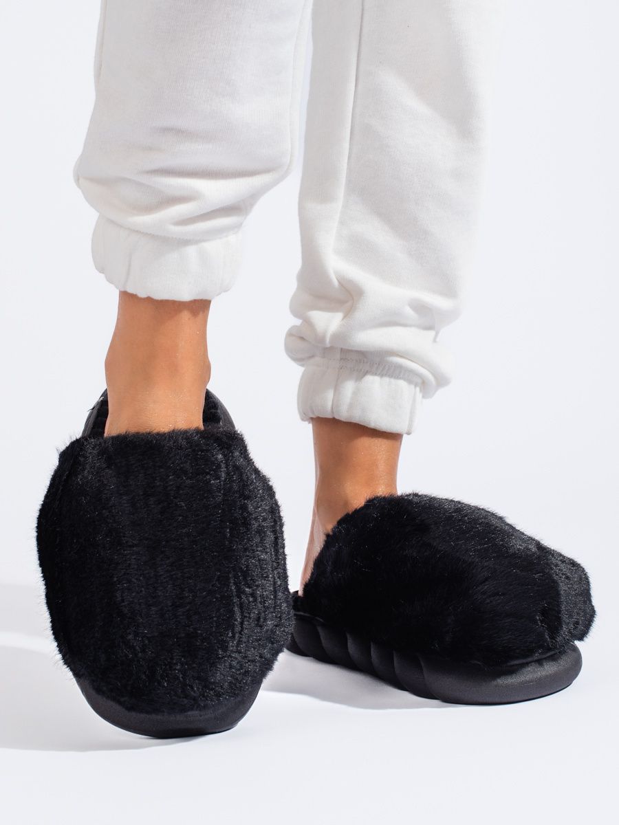 Black fur slippers on a thick sole