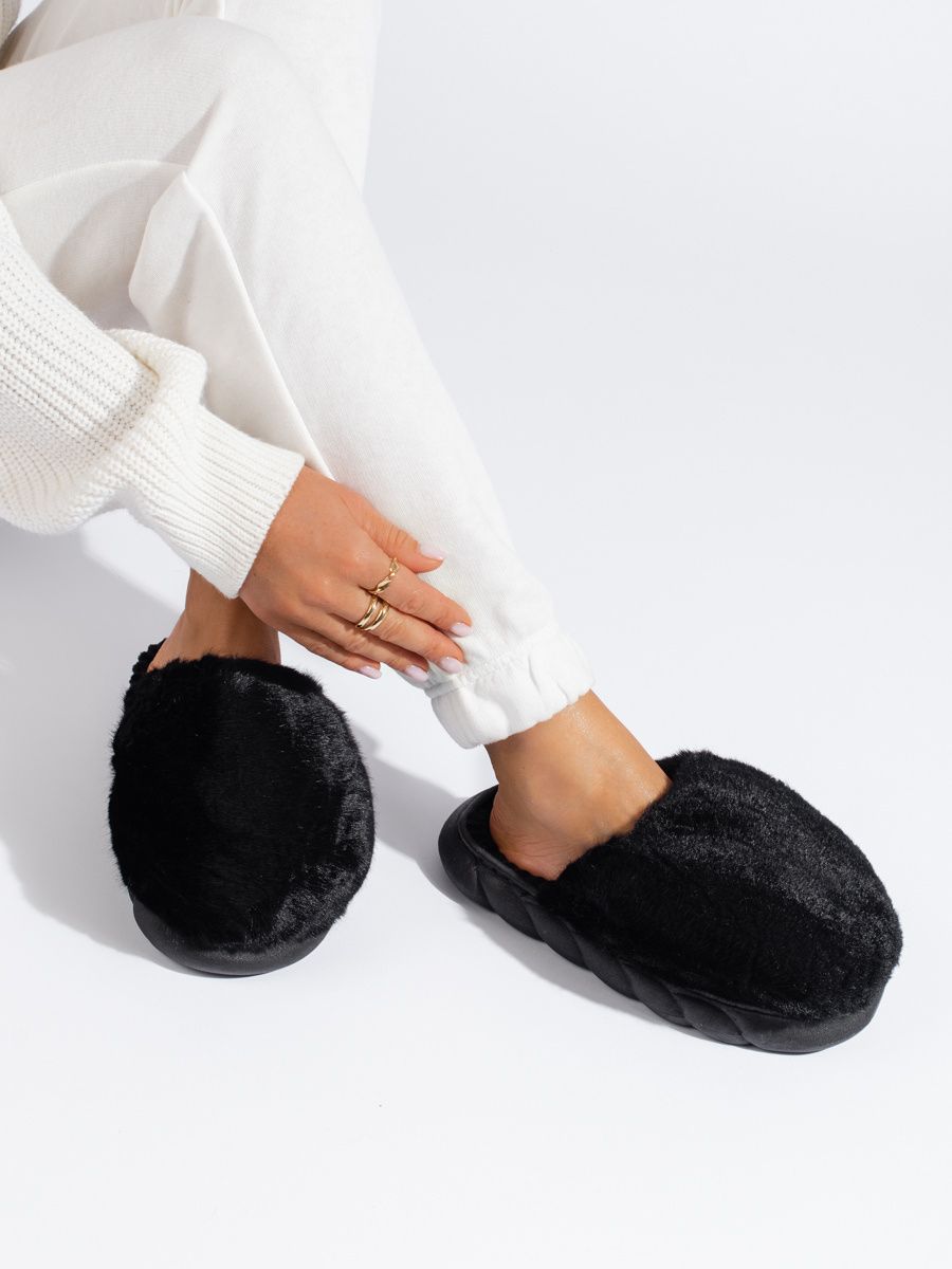 Black fur slippers on a thick sole