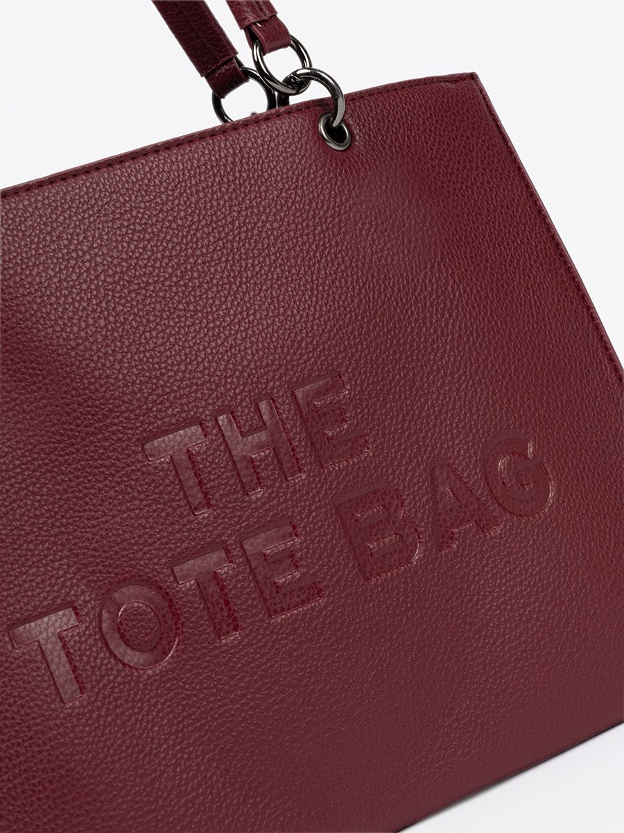 Burgundy tote bag with embossed lettering