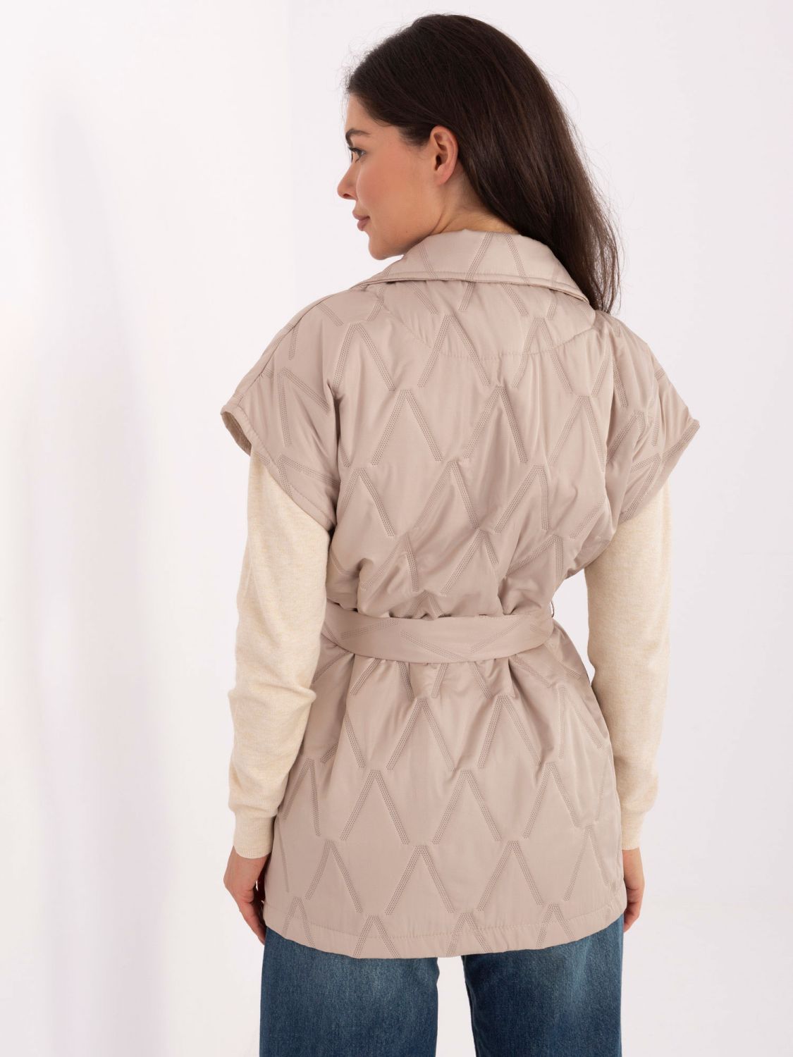 Beige quilted vest with belt and brooch
