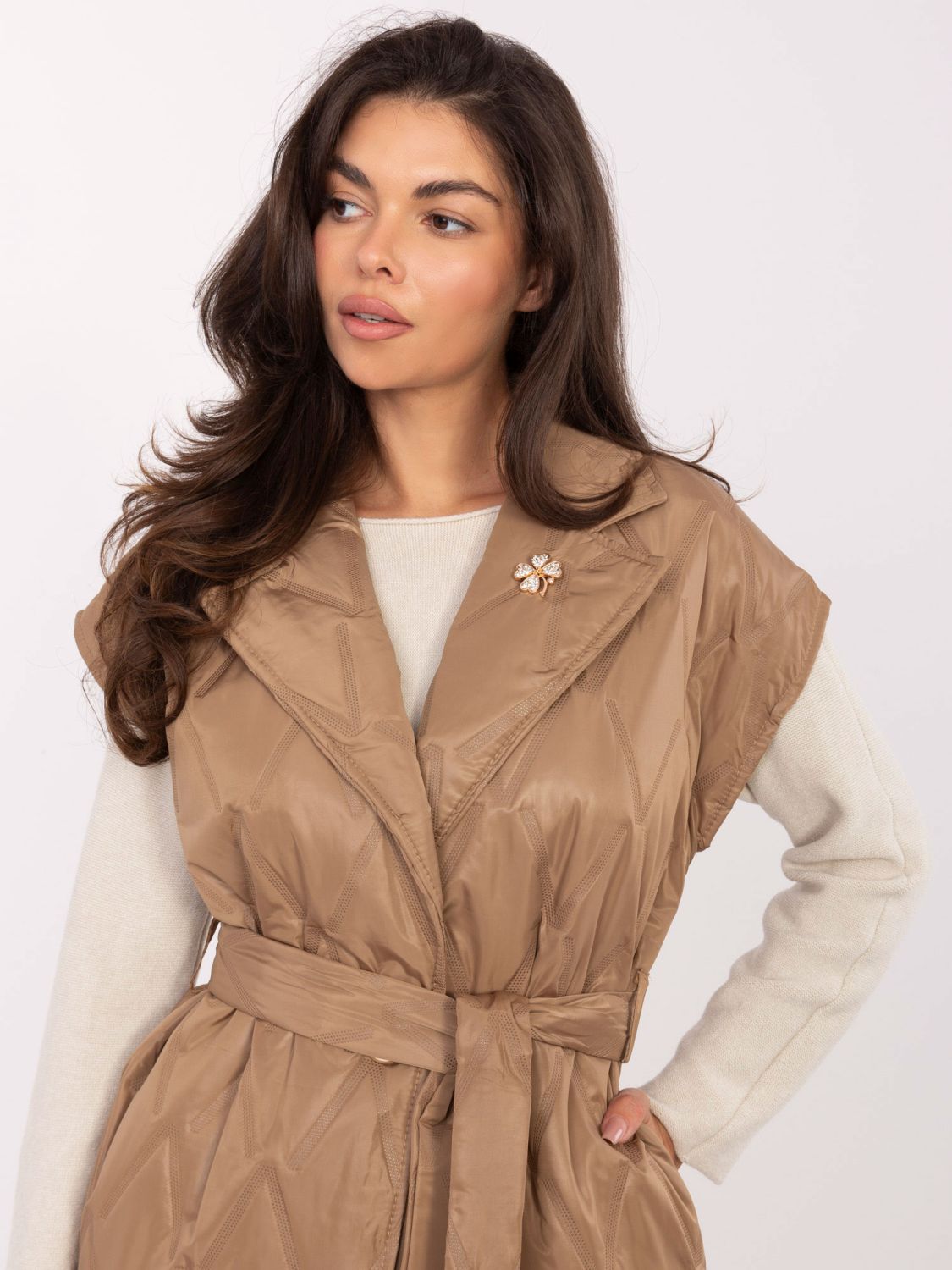 Elegant brown quilted vest with belt and brooch