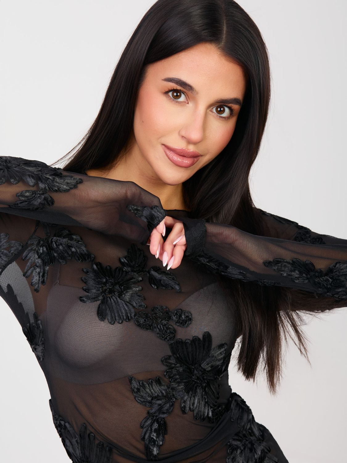Elegant black blouse with floral appliqué and embroidery