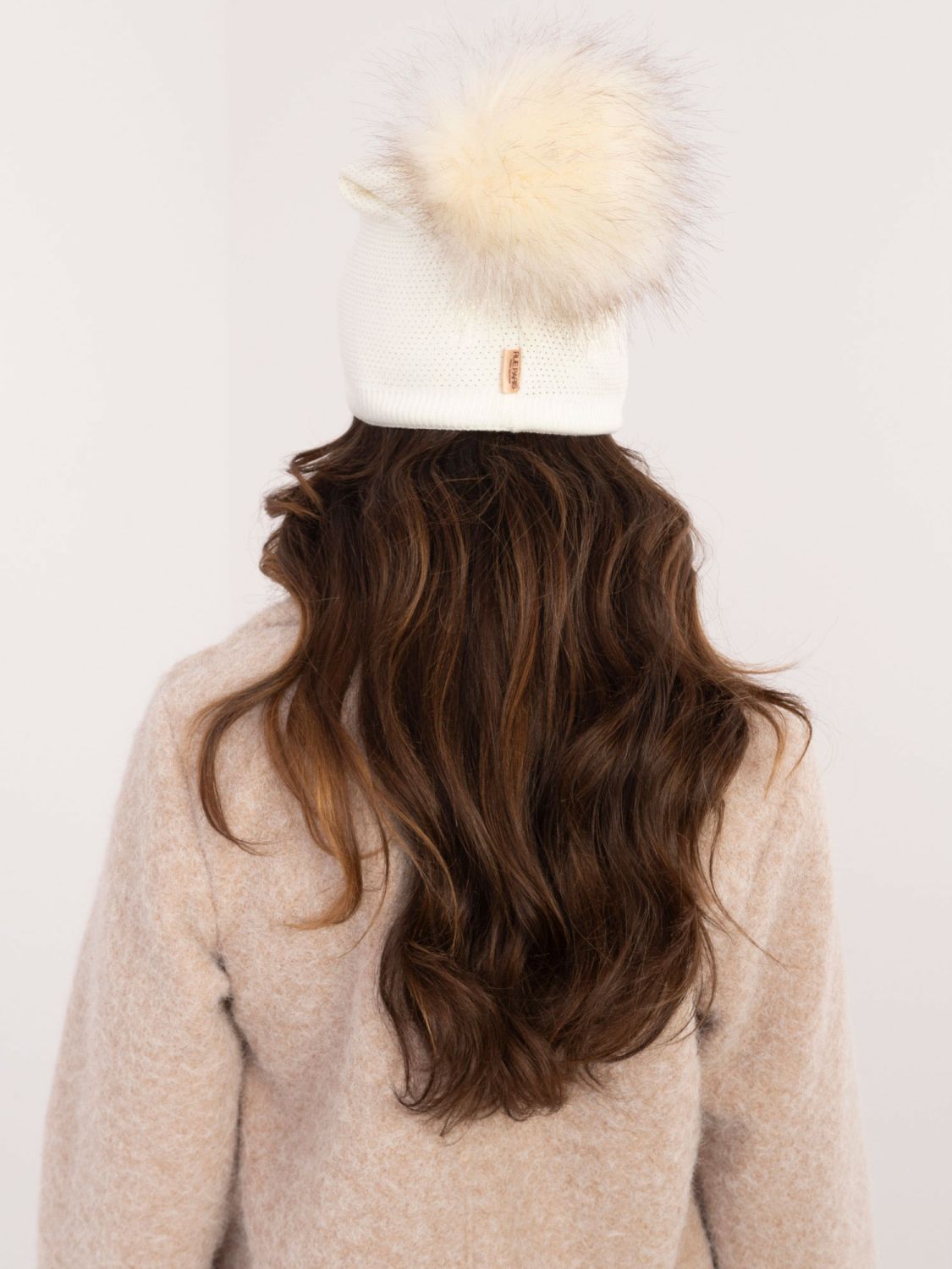 Elegant ecru beanie with pompom