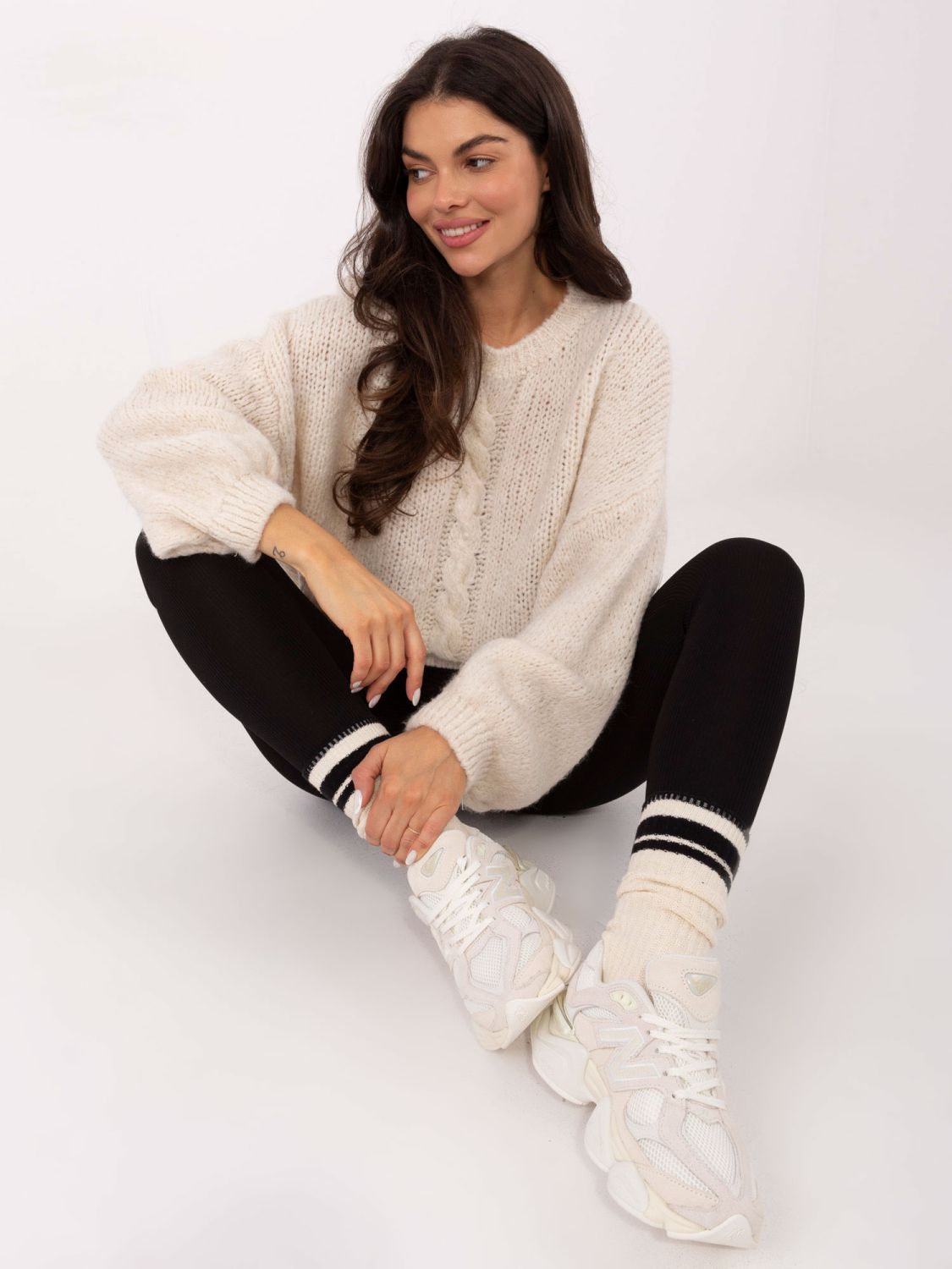 Beige sweater with round neckline and textured pattern