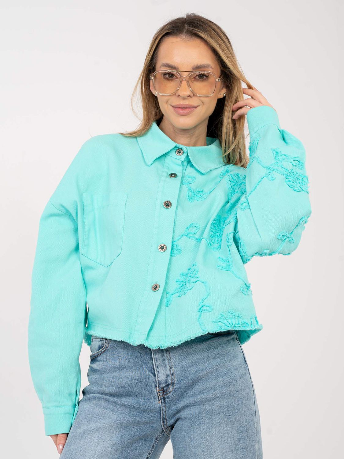 Turquoise women's denim jacket with floral appliqué