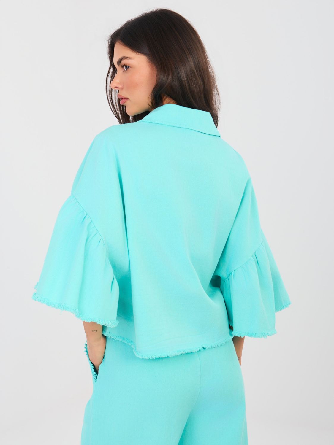 Short denim jacket with ruffle in turquoise