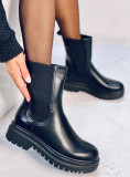 Black boots made of eco-leather on the platform