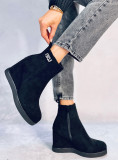 Black ankle boots on a wedge heel