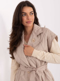 Beige quilted vest with belt and brooch