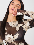 Elegant black blouse with beige embroidery and floral motif