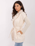 Elegant beige quilted vest with belt and brooch